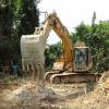 The excavator made itself a clearing at the designated dig site and got down to the pay gravels.